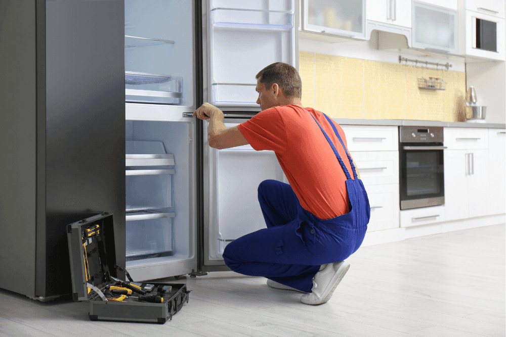 Dubai Repair Pro technician repairing a refrigerator in Dubai home