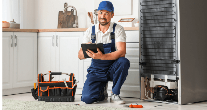 Certified refrigerator technician performing diagnostics in Dubai